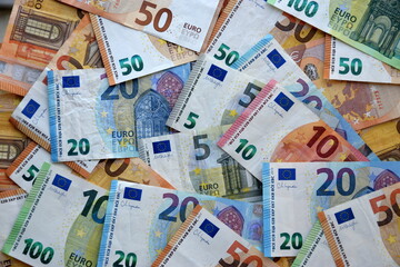 Many european euro money bills in chaotic arrangement. Pile of eur banknotes with different colors and condition