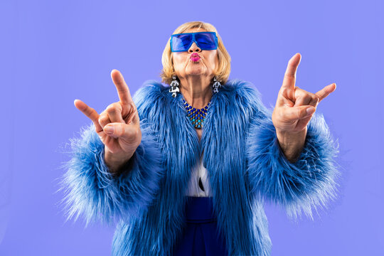 Happy beautiful senior asian woman with stylish clothing portrait on colorful isolated background - Stylish old lady with extravagant cool look