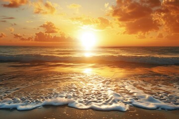 Obraz premium A beautiful sunset scene with the sun dipping into the ocean on a peaceful beach