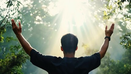 Sunlit Embrace: A man raises his arms in a gesture of joy and gratitude, silhouetted against a breathtaking background of sunbeams piercing through lush green foliage. The image evokes a sense of peac