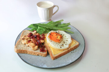 bread with egg and cheese topping or  sunny side up egg , lettuce and almond with dried cranberry and milk