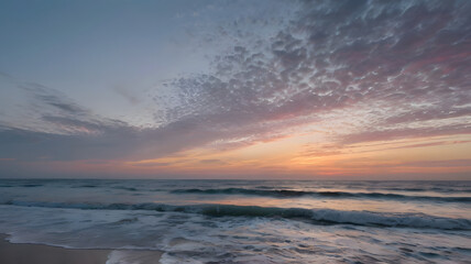 This image could be named Evening Sunset Over the Sea with Orange Sky and Gentle Waves on the Beach