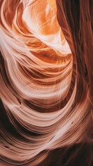 Obraz premium Natural rock formations twist and weave dramatically as sunlight filters through the canyon's depths, revealing stunning layers of color and texture in a breathtaking display of nature’s artistry