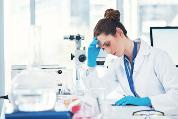 Tired, woman or scientist in lab with science study for research to test experiment with deadline or stress. Headache, exhausted physicist or writing checklist report for mpox vaccine development