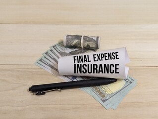 banknotes, pen and fold paper with the word Final Expense Insurance. insurance concept