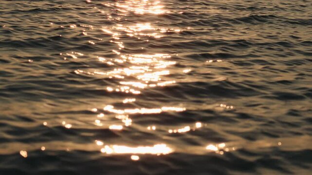 Slow motion handheld shot of waves at sunset
