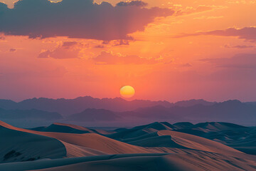 Sunset over a desert with sand dunes
