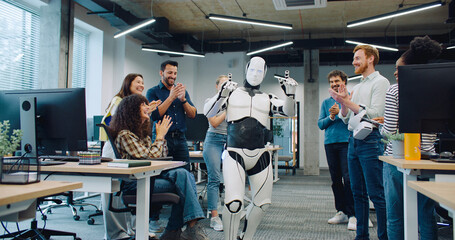 Camera moving closer while keeping focus on white modern bionic person. Creators surrounding robot...