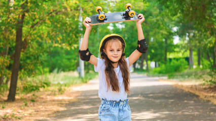 Girl skateboard with safety equipment - helmet, knee and elbow pads. Safe summer activity. Kids activity.
