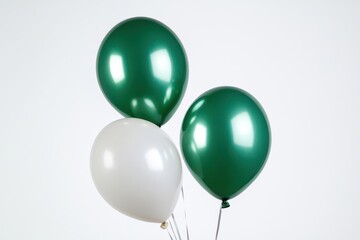 Three glossy balloons in green and white colors on a neutral background, perfect for celebrations and events.