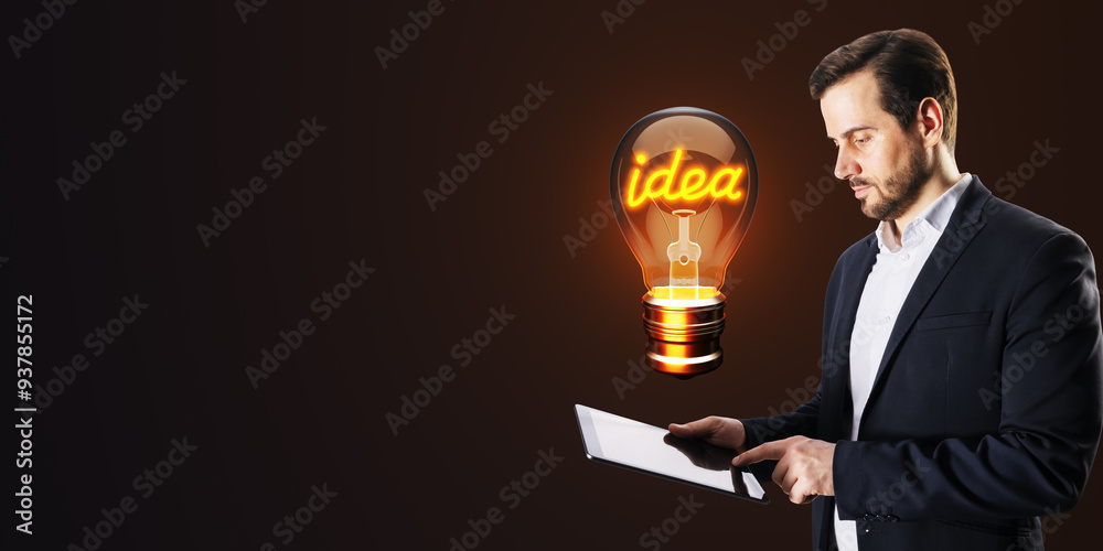 Poster businessman holding a tablet with a glowing lightbulb symbolizing an idea on a dark background.