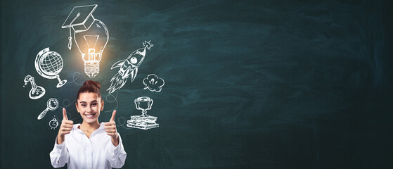 Woman giving thumbs up with education-related sketches on a chalkboard.