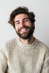 Fototapeta premium A smiling man with a beard wearing a sweater