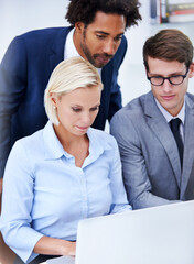 Obraz premium Team, help or laptop in office for typing, support or manager at table for feedback. Men, woman or tech in agency for business, plan and collaboration at computer for discussion or performance review