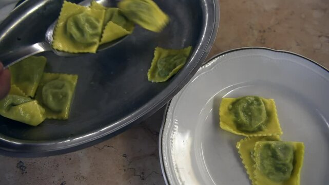 Typical recipe of emilian food valley: Green tortelli stuffed with chard served on a plate in a restaurant of Reggio Emilia, Emilia Romagna, Italy