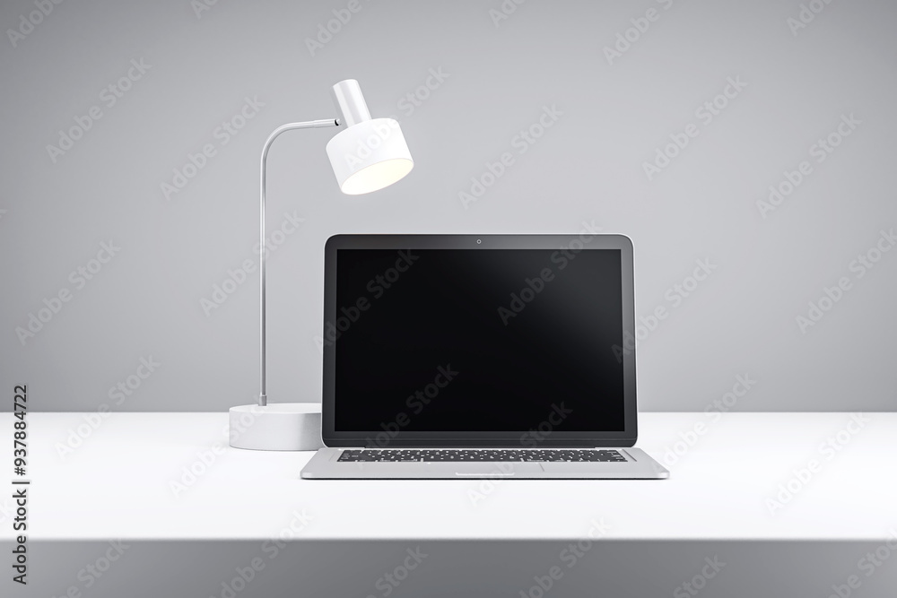 Poster laptop and desk lamp on a modern white desk in a minimalist grey room. 3d rendering