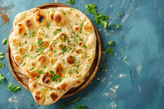 Indian bread above view on blue table. Homemade naan bread 