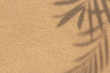 Sand on a beach with palm leaf shadow silhouette background. Tropical beach background concept