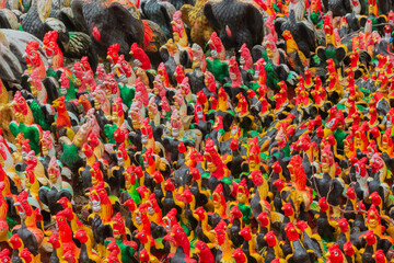 Background from many colorful ceramic rooster figurines at Wat in Ayutthaya, Thailand. Chicken...