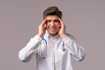 Doctor man with headache on white. Sick medical specialist puts hand on head