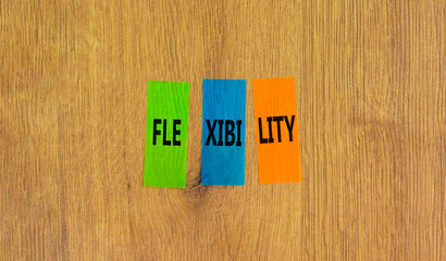 Flexibility symbol. Concept word Flexibility on beautiful colored paper. Beautiful wooden...