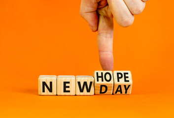 New day and hope symbol. Concept word New day New hope on beautiful wooden cubes. Beautiful orange table orange background. Businessman hand. Business new day and hope concept. Copy space.