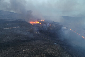 aerial drone view of a forest fire on a mountain at nightfall