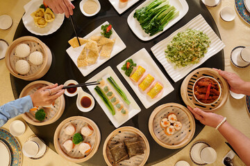 Top view of family eating Chinese meal in the restaurant