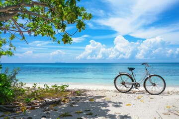 Fototapeta premium A bicycle parked on a sandy beach next to the ocean, suitable for use in travel or outdoor-themed projects