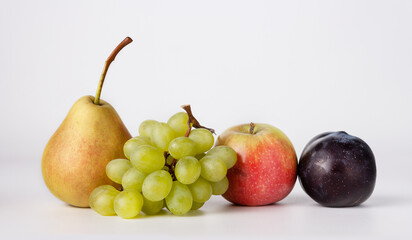 pear, grape, apple, plum on a white background, close-up