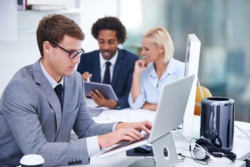Fototapeta premium Serious, laptop and man with glasses, office and thinking of financial report, review and accountant. Typing, bookkeeper and person with project for budget of company, tech and professional with idea