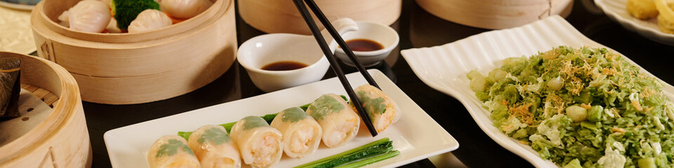 Header with woman eating rolls in the restaurant