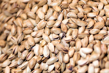 Lots of pistachios, background with tasty nuts.