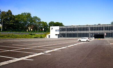 Parking lot with only one parked car. White lines. Designation of parking spaces. Transport, rest,...
