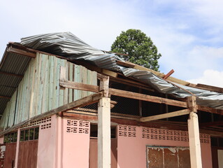 A house roof damaged by storm winds