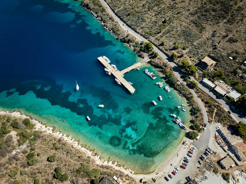 Aerial drone panorama landscape of beach and dock for yachts and boats near Porto Palermo Castle (Albanian: Kalaja e Porto Palermos), Himare in southern Albania