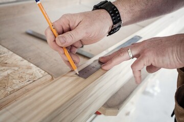 measuring timber for cutting with a pencil and mental ruler