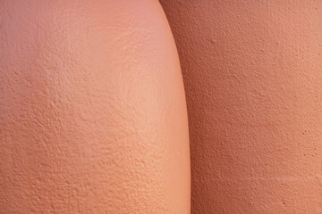 Close-up of the surfaces of two ceramic clay amphorae reminiscent of the lines of the human body. Background. Texture.