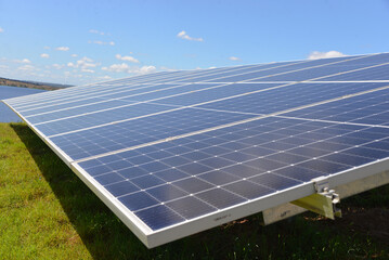 Open space solar panels installation with photovoltaic modules on a hay field in rural farm on...
