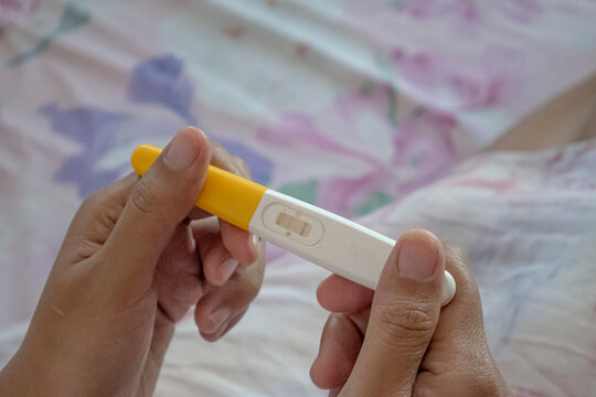 Close up pregnancy test pack hold by hand's woman.