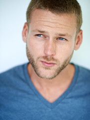 Fototapeta premium Ideas, thinking and face of man in studio with casual fashion, confidence and creative inspiration. Planning, insight and young professional with pride, cool style and decision on white background