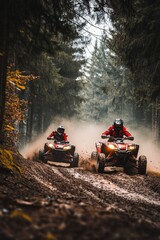 Action shot of two ATV riders speeding through a forest trail