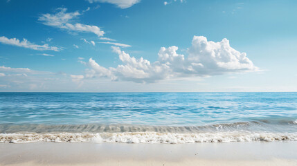 Fototapeta premium A serene view of the calm ocean under a clear blue sky, with gentle waves softly lapping the sandy shore.