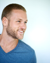 Obraz premium Smile, thinking and face of man in studio with casual fashion, confidence and creative inspiration. Happy, ideas and young professional with pride, cool style and mockup space on white background