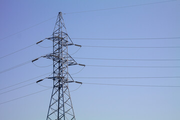 Iron power line pole against the sky, electricity and technology.