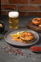 Portion of gourmet grilled salmon steak with beer and pretzels