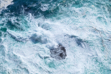 Obraz premium Waves as background. Huge ocean waves near the coast. Nature. Background and wallpaper in nature. Water surface as texture. Blue water and sea foam.