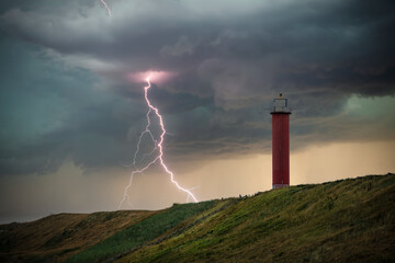 View of the Grote Kaap lighthouse near Julianadorp/NL during a thunderstorm