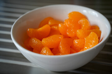 Tangerines from a can served in a white bowl
