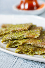 Savor the exquisite taste of traditional Gaziantep Katmer, a flaky Turkish dessert layered with green pistachios and syrup. Perfect for those seeking a sweet delight!